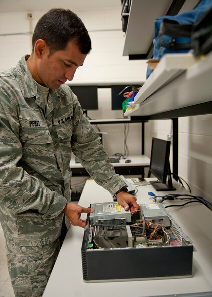 U.S. Air Force Airman 1st Class Gustavo Perez, 23d Communications Squadron, disassembles a computer at a workbench Aug. 30, 2012, at Moody Air Force Base, Ga. There are many different squadrons that support the Air Force’s communication mission, such as asset management, vulnerability reduction, troubleshooting everyday computer problems and providing base personnel communication through Land Mobile Radios. (U.S. Air Force photo by Senior Airman Eileen Meier/Released)