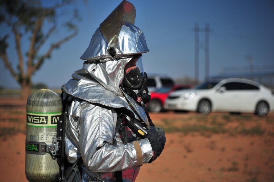 A member with the 27th Special Operations Civil Engineer Squadron fire department checks his equipment during a major incident response exercise at Cannon Air Force Base, N.M., Sept. 20, 2012. Emergency responders from across the installation as well as several external agencies were included in the exercise to better train and prepare base personnel for real world situations. (U.S. Air Force photo/Airman 1st Class Alexxis Pons Abascal)  