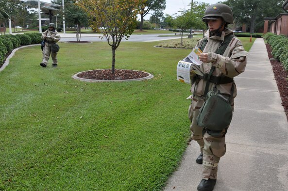 U.S. Air Force Tech. Sgt. Colette Graham, 4th Fighter Wing Public Affairs, and Senior Airman Shene Pettiford, 4th FW knowledge operations manager, perform a post attack reconnaissance sweep after a simulated attack during Phase II of Operational Readiness Exercise Coronet Warrior 12-04 at a simulated deployed location on Seymour Johnson Air Force Base, N.C., Sept. 20, 2012. Airmen complete PAR sweeps to check for wounded personnel, unexploded ordnance and any chemical presence. (U.S. Air Force photo/Staff Sgt. Courtney Richardson/Released)