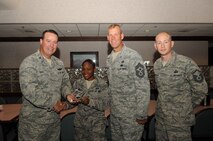 Col. Timothy Bush, 319th Air Base Wing commander, presents Airman 1st Class Adena Coney, 319th Wing Staff Agencies, with a Diamond Sharp Award Sept. 20, 2012, on Grand Forks Air Force Base, N.D., accompanied by 319th ABW Command Chief Master Sgt. David Carlson and Master Sgt. Keelan Rasmusson, 319th WSA acting First Sergeant. The Diamond Sharp Award is given to Airmen who epitomize service before self and strive for excellence at work and off duty. (U.S. Air Force photo by Staff Sgt. Amanda N. Grabiec)