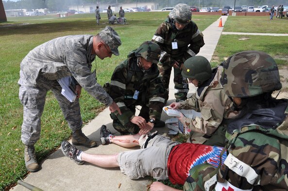 Airmen administer self-aid buddy care during Phase II of Operational Readiness Exercise Coronet Warrior 12-04 at a simulated deployed location on Seymour Johnson Air Force Base, N.C., Sept. 20, 2012. Airmen receive SABC training in order to provide immediate care to the injured until medical technicians arrive. (U.S. Air Force photo/Staff Sgt. Courtney Richardson/Released)