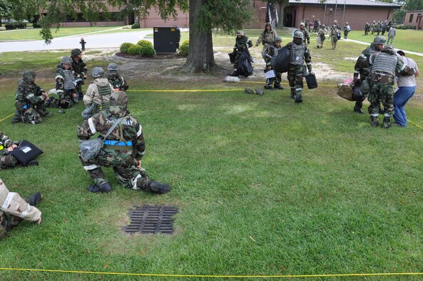 Airmen from the 4th Fighter Wing evacuate their facility into a mock bunker after an attack during Phase II of Operational Readiness Exercise Coronet Warrior 12-04 at a simulated deployed location on Seymour Johnson Air Force Base, N.C., Sept. 20, 2012. Exercise evaluators test the wing's ability to rapidly deploy, survive and operate under simulated conventional, chemical and biological conditions.  (U.S. Air Force photo/Staff Sgt. Courtney Richardson/Released)