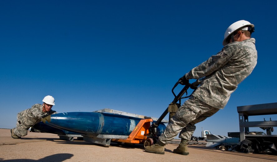 Airmen from the 7th Maintenance Group prepare to assemble munitions during the 3rd annual Global Strike Challenge Sept. 19, 2012, at Dyess Air Force Base, Texas. During the first event, the team had a maximum of 90 minutes to assemble 18 Joint Direct Attack Munitions on a munitions assembly conveyor. (U.S. Air Force photo by Airman 1st Class Jonathan Stefanko/ Released)