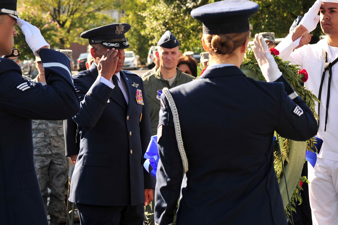 Former prisoner of war U.S. Air Force Col. (Ret.) Norman A. McDaniel and fellow service members salute a wreath laid in remembrance of those missing in action during a ceremony Sept. 21 at the Airmen Memorial Building in Suitland, Md. McDaniel was shot down and captured on July 20, 1966, while flying over North Vietnam. He remained a prisoner of war until released on February 12, 1973. (U.S. Air Force photo by Senior Airman Steele C. G. Britton)
