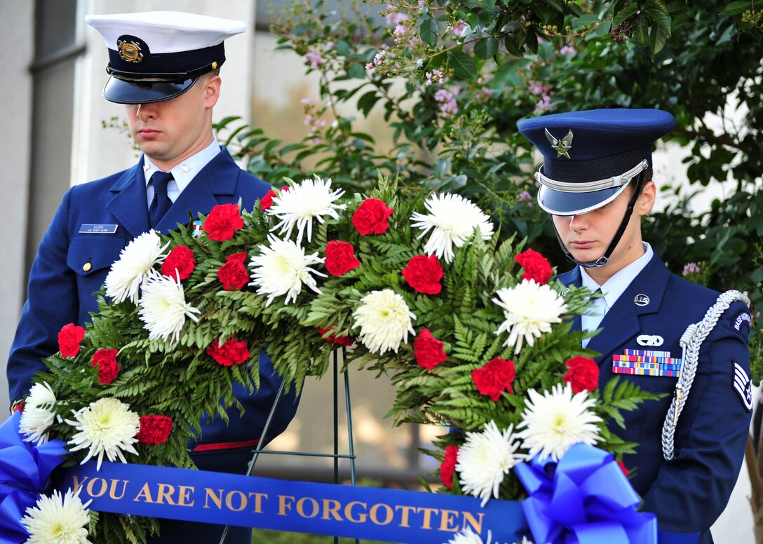 U.S. Air Force and Coast Guard Ceremonial Guardsmen bow their heads in prayer during a Prisoner of War Remembrance Ceremony Sept. 21 at the Airmen Memorial Building in Suitland, Md. The local Air Force Sergeant's Association chapter for Joint Base Andrews hosted the ceremony, honoring POWs and remembering those still missing in action. (U.S. Air Force photo by Senior Airman Steele C. G. Britton)  