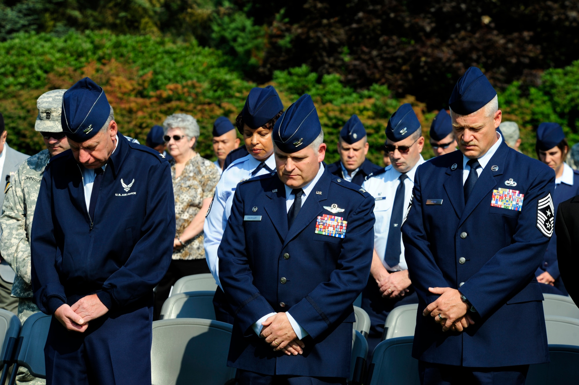 From left to right, Col. Bruce Bowers, 446th Airlift Wing commander, Col. Paul Eberhart, 62nd Airlift Wing Operations Group commander and Chief Master Sgt. Gordon Drake, 62nd AW command chief, pause for a moment of reflection during the Sept. 17, 2012 POW/MIA remembrance ceremony at Memorial Grove park, Joint Base Lewis-McChord, Wash. More than 70 members from across Team McChord came out to show their respects. (U.S. Air Force photo/Master Sgt. Todd Wivell)