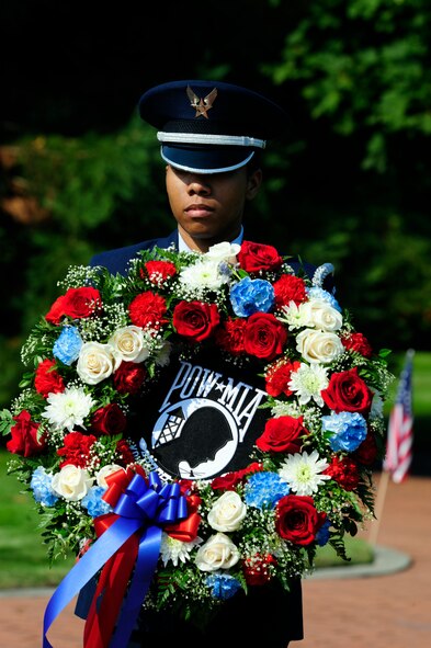 Senior Airman Chiesa Moffett, 62nd Airlift Wing base honor guard member, carries the POW/MIA wreath to its resting place during the POW/MIA remembrance ceremony at Memorial Grove Park, Joint Base Lewis-McChord, Wash., Sept. 17, 2012. Six different POW/MIA veterans were in attendance for this ceremony. (U.S. Air Force photo/Master Sgt. Todd Wivell) 

