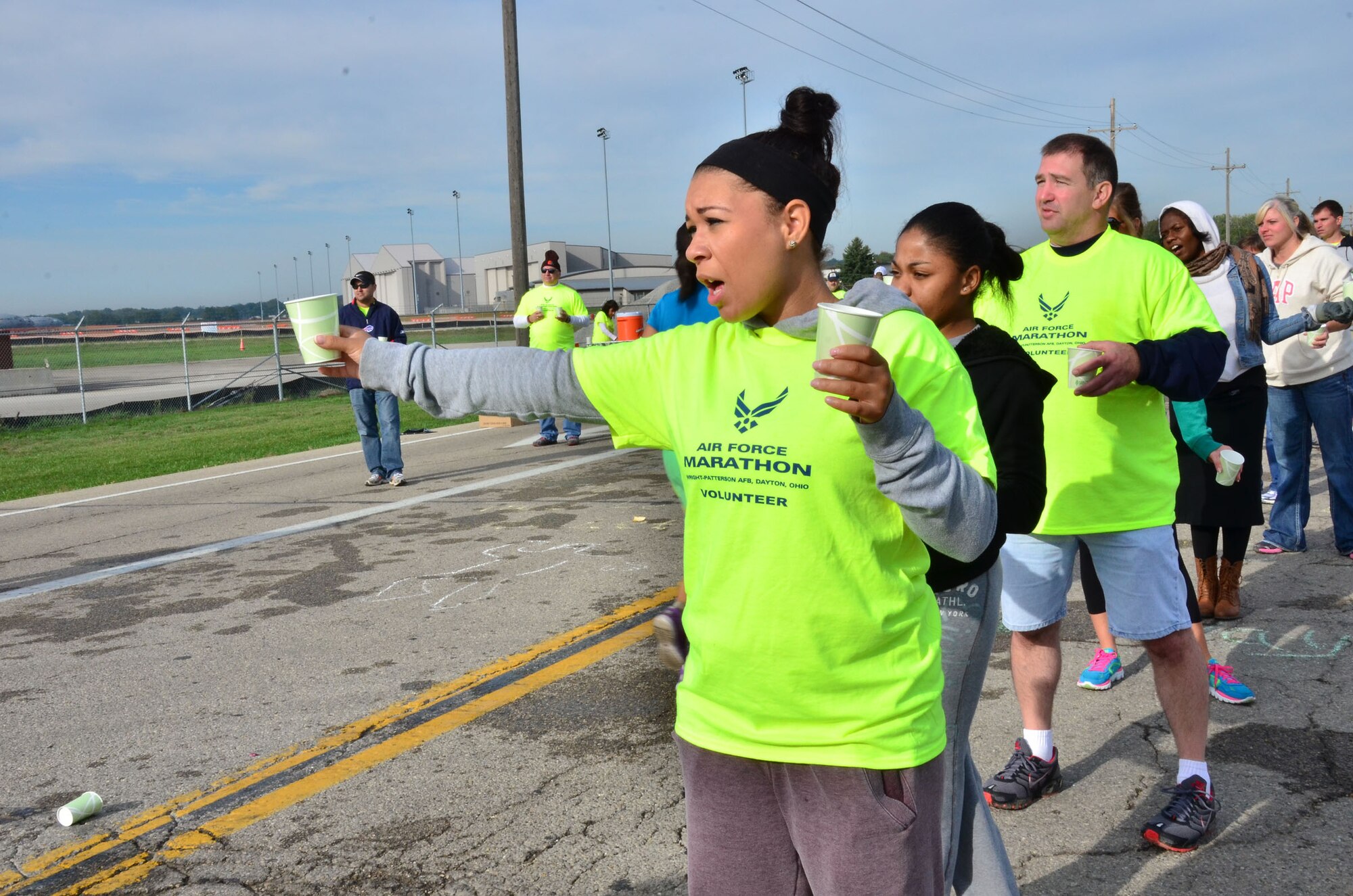 WRIGHT-PATTERSON AIR FORCE BASE, Ohio – Staff Sgt. Nastasskia Gerald, 445th Services Sustainment Flight journeyman, provides water to runners participating in the 2012 Air Force Marathon Sept. 15. Wing volunteers manned a hydration station with other volunteers along the route to provide the runners a drink and a snack along their way to the finish line. (U.S. Air Force photo/Staff Sgt. Amanda Duncan)