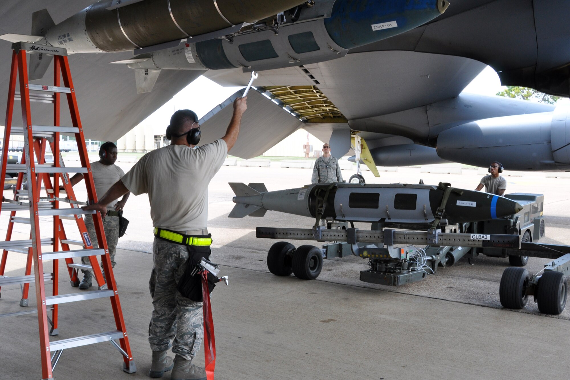 Tech. Sgt. Matteo Gerrits guides Senior Airman Tyshaun Owens into place during a weapons load competition at Barksdale Air Force Base, La., Sept. 13, 2012. Gerrits and Owens were part of a team participating in the weapons loading portion of the 2012 annual Global Strike Challenge at Barksdale. Both Airmen are weapons loaders assigned to the 307th Maintenance Squadron. (U.S. Air Force photo by Master Sgt. Jeff Walston) 