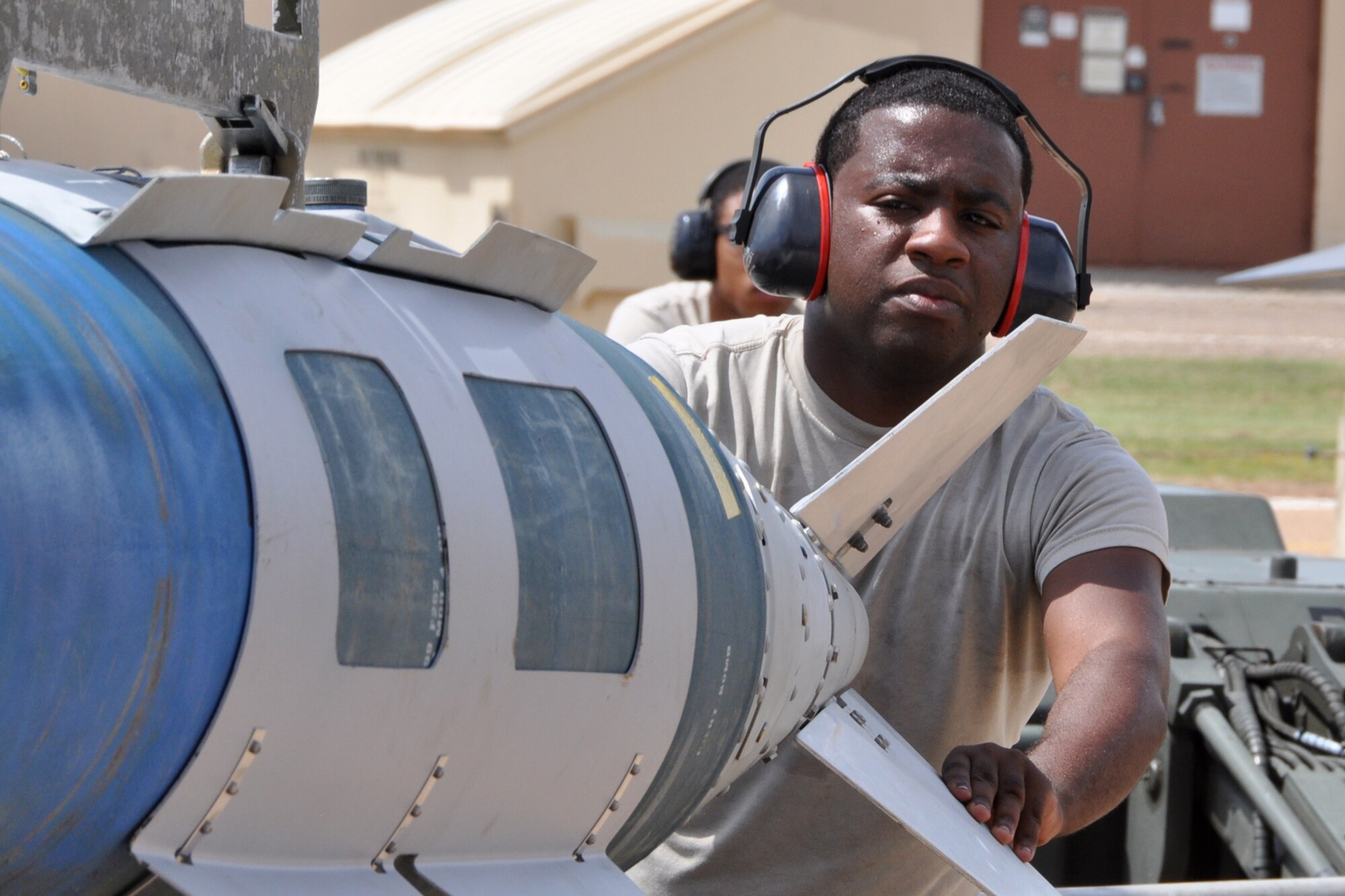 Senior Airman Coreyaunte Hayes, a weapons loader assigned to the 307th Maintenance Squadron, guides a GB U-31 bomb during a weapons load at Barksdale Air Force Base, La., Sept. 13, 2012. Hayes was participating in the weapons loading portion of the 2012 annual Global Strike Challenge at Barksdale. (U.S. Air Force photo by Master Sgt. Jeff Walston)   