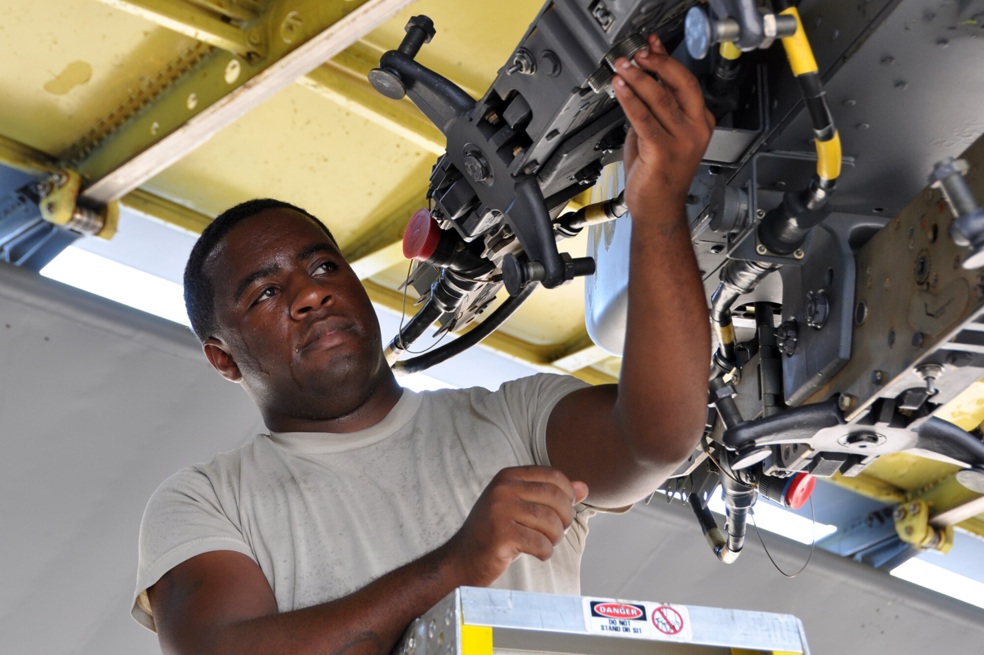 Senior Airman Coreyaunte Hayes, a weapons loader assigned to the 307th Maintenance Squadron, loads an impulse cartridge into a bomb rack during a weapons load at Barksdale Air Force Base, La., Sept. 13, 2012. Hayes was participating in the weapons loading portion of the 2012 annual Global Strike Challenge at Barksdale. (U.S. Air Force photo by Master Sgt. Jeff Walston)   