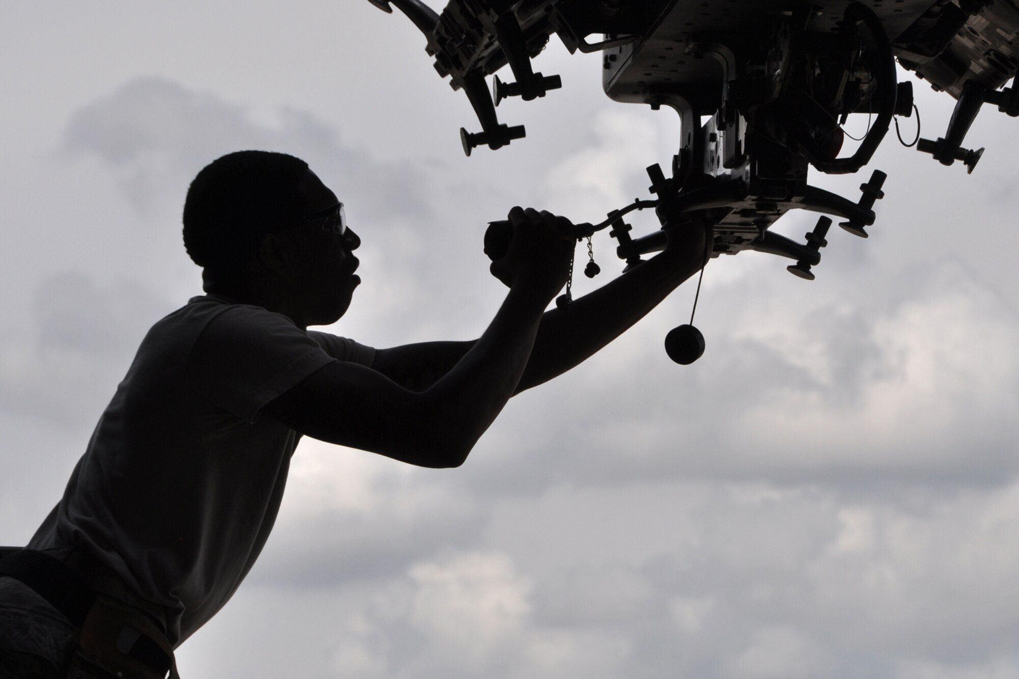 Senior Airman Tyshaun Owens, a weapons loader assigned to the 307th Maintenance Squadron, checks a bomb rack on a B-52 Stratofortress for stray voltage before a weapons load at Barksdale Air Force Base, La., Sept. 13, 2012. Owens was participating in the weapons loading portion of the 2012 annual Global Strike Challenge at Barksdale. (U.S. Air Force photo by Master Sgt. Jeff Walston)   