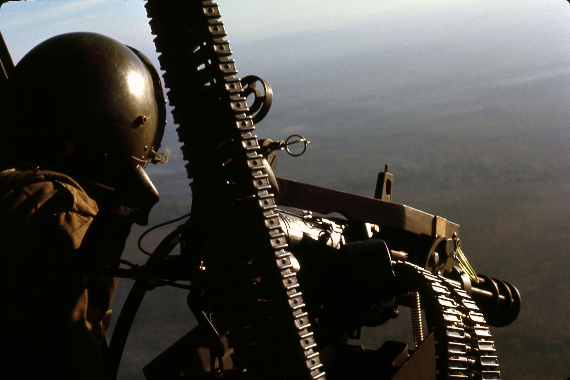 A UH-1 gunner manning a GAU-2 minigun that fired 7.62mm ammunition. (U.S. Air Force photo)
