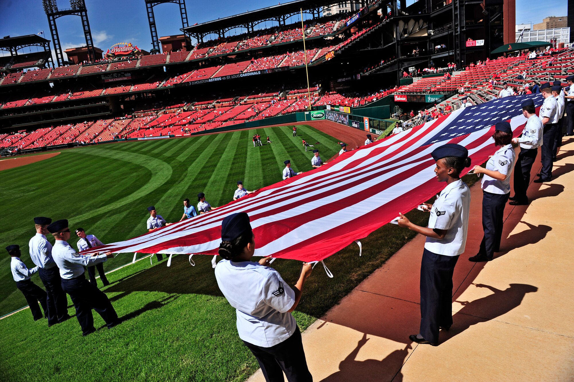 Twenty-two Airmen from Scott Air Force Base hold the flag in Busch Stadium prior to a St. Louis Cardinals baseball game where they were invited to wave the American flag during the national anthem Sept. 20, 2012. Scott AFB has been involved in various shows during sporting events but this was the first time Airmen were invited out to display the flag for more than 34,000 people to see. (U.S. Air Force photo/ Staff Sgt. Ryan Crane)