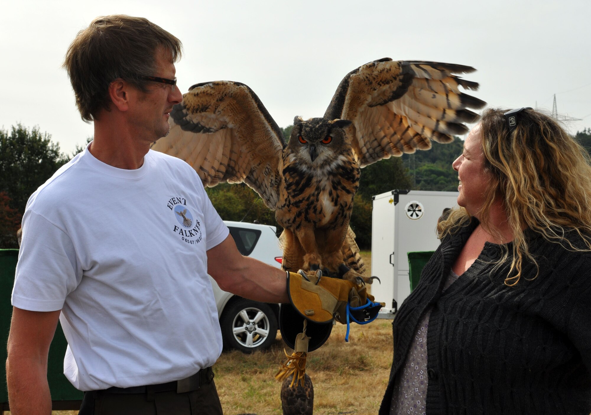 WITTLICH, Germany - A local falconer shows off his owl to a visitor at the Wittlich Commerce Fair Sept. 21 here. The falconer explained that he takes the owls and other birds to schools for teaching children. People will find 231 local exhibitors presenting their trade and businesses for the weekend. The Wittlich Commerce Fair will be open Sept. 22 -23 from 10 a.m. - 7 p.m. and Sept. 24 from 10 a.m. - 6 p.m. (U.S. Air Force photo by Iris Reiff/Released)