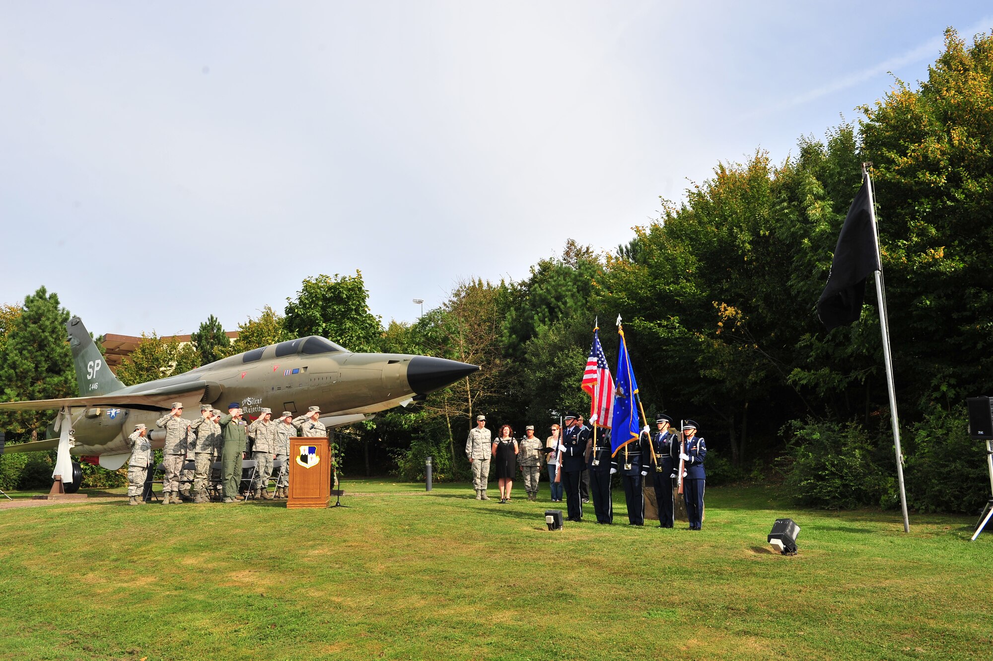 SPANGDAHLEM AIR BASE, Germany – Members of the 52nd Fighter Wing Honor Guard post the colors as 52nd FW members salute during the Prisoner of War Missing in Action Ceremony at the air park here Sept. 21. The ceremony is held every year to remember those who have served and been taken prisoner or have been listed as MIA. (U.S. Air Force photo by Airman 1st Class Dillon Davis/Released)