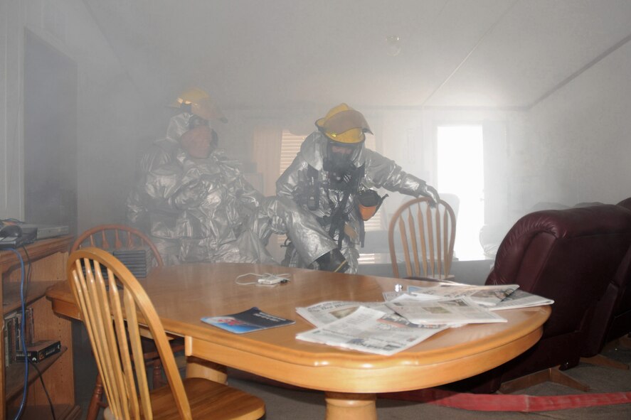 Senior Airman Ray Surber (left) and Staff Sgt. Kristopher Ruszkowski (right) remove a victim from a simulated structure fire at the 132nd Fighter Wing (132FW), Des Moines, Iowa on September 19, 2012.  The 132FW is currently engaged in Operational Readiness Exercise, "Operation Desert Veil".  (US Air Force photo/Staff Sgt. Linda E. Kephart)(Released)