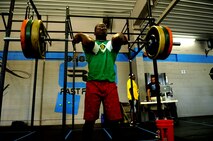 Airman 1st Class Greg Talbott, 319th Civil Engineer Squadron, performs an Olympic lift during a workout in the Cloudy Town Throw Crossfit competition in St. Cloud, Minn., Sept. 15, 2012. CrossFit is a training system composed of functional movements that are used in daily lives such as lifting and jumping. Talbott placed 18th out of 54 competitors. (U.S. Air Force photo by Staff Sgt. Amanda N. Grabiec)
