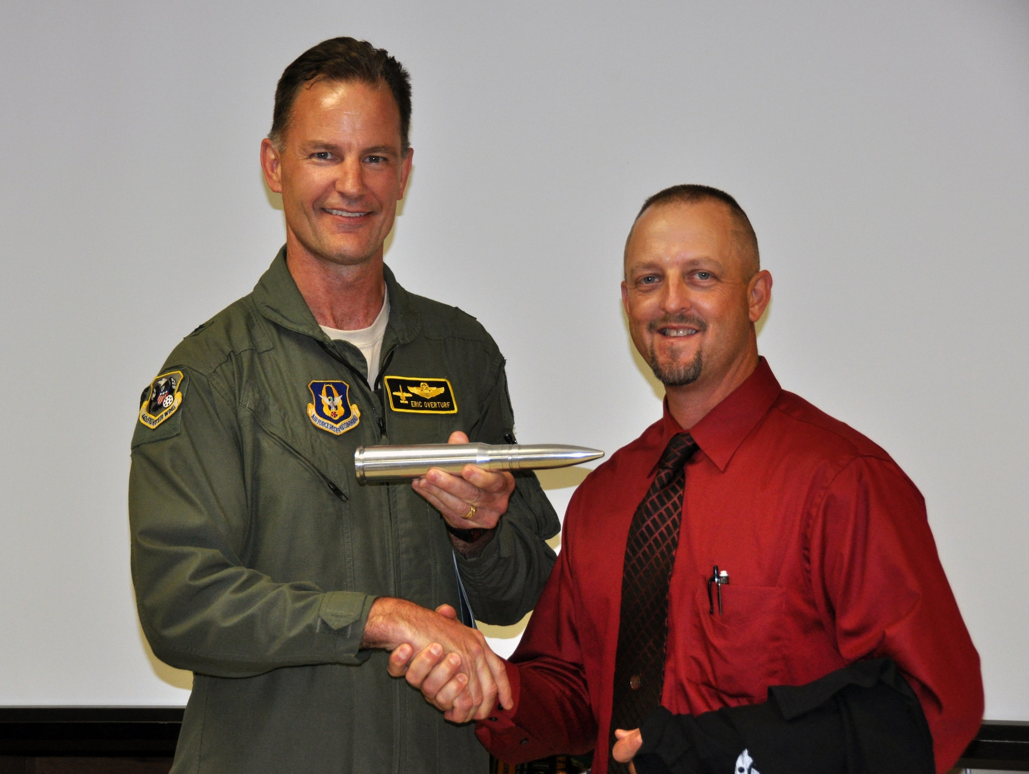 WARRENSBURG, Mo. -- Brig. Gen. Eric S. Overturf, 442nd Fighter Wing commander, presents a 30 mm bullet replica, to Lyle R. Kreisel, facility manager for the Warrensburg RVI school district here, Sept. 18, 2012. Kreisel, the supervisor of a reservist at the wing, greatly contributed to earning the ProPatria award given by the Employer Support of the Guard and Reserve to the district. The ProPatria is a state-level award earned by the employer who best supports his or her reservist during military duty. The 442nd Fighter Wing is an A-10 Thunderbolt II Air Force Reserve unit at Whiteman Air Force Base, Mo. (U.S. Air Force photo by Staff Sgt. Danielle Johnston/Released)