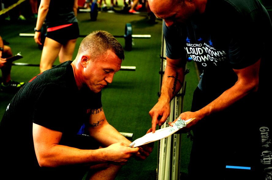 Senior Airman Matthew Lawrence, 319th Civil Engineer Squadron, checks the points he received after completing the fourth round workout in the Cloudy Town Throw Down CrossFit competition in St. Cloud, Minn., Sept. 15, 2012. CrossFit is a training system composed of functional movements that are used in daily lives such as lifting and jumping. Lawrence placed 13th out of 54 competitors. (U.S. Air Force photo by Senior Airman Abel Vazquez)