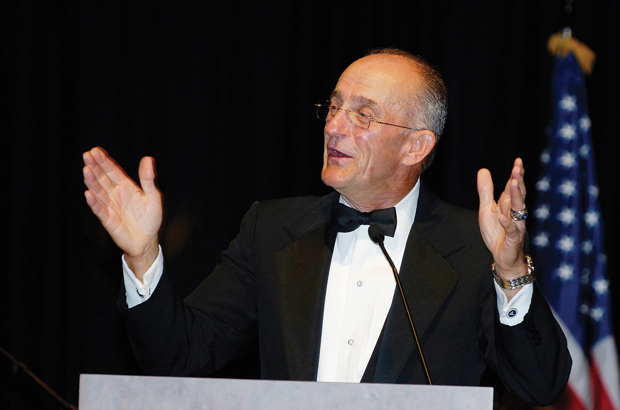 In his presentation weaving humor, Air Force heritage and a deep devotion to duty, featured speaker retired Maj. Gen. Edward Mechenbier speaks to more than 700 Tinker and community members at the Sept. 15 Air Force Birthday Ball in Norman. General Mechenbier retired with a long list of accomplishments to his name. In 1967 flying his 80th combat mission over North Vietnam, he was shot down and held as a POW for nearly six years. (Air Force photo by Margo Wright)
