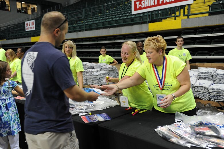 Registrants pick up bibs and goodie bags at the Air Force Marathon Expo.  Hundreds of volunteers staff the two-day event is held each year in the Nutter Center.
