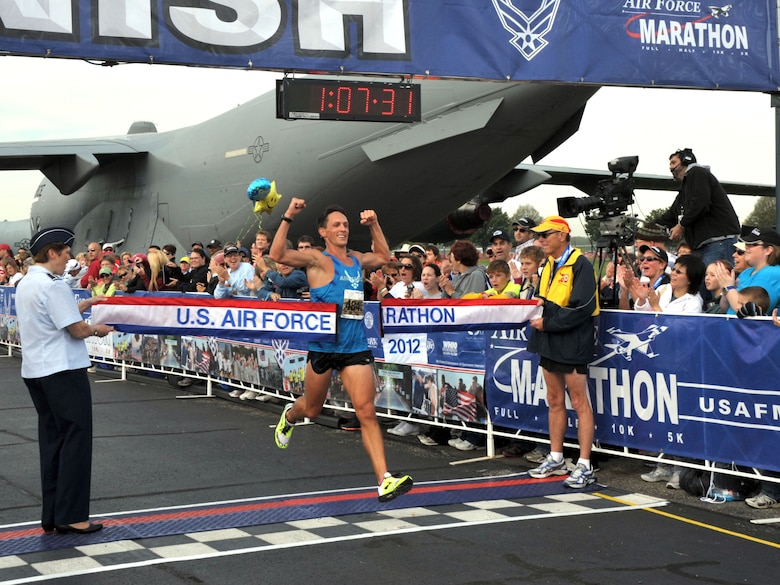Capt. Ben Payne crosses the finish line at the Air Force Marathon capturing the Half Marathon crown with an official time of 1:07:32.  (U.S. Air Force photo/Michelle Gigante)  

