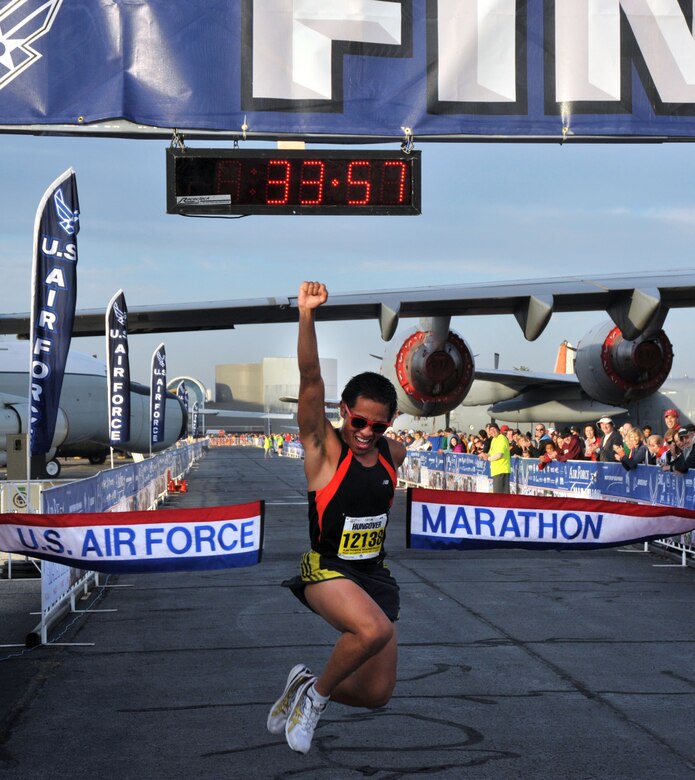 Kristoffer Chacon, 25, of Lomita, Calif., launches a celebratory jump across the finish line to capture the 10k crown in the Air Force Marathon at 33:57.  Chacon was also the Men's Active Duty winner for the 5k.  (U.S. Air Force photo/Michelle Gigante)


