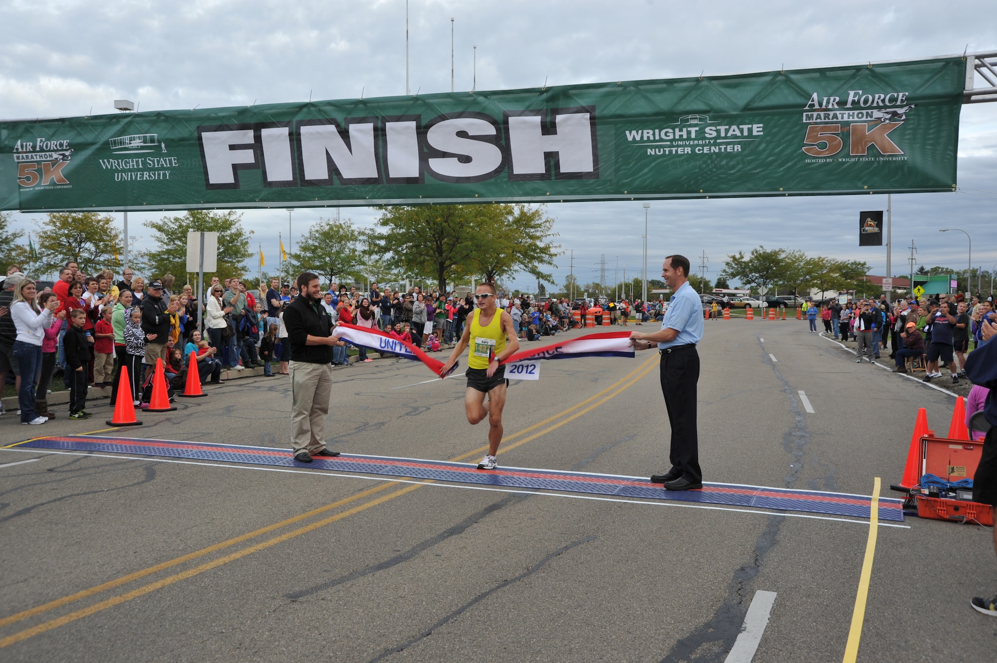 Kory Kennedy, 22, of Kokomo, IN., crosses the finish line at 16:39 to take first place for the Men's 5k race in the 2012 Air Force Marathon.  The 5k is always hosted on the grounds of Wright State University in partnership with the Air Force.  
