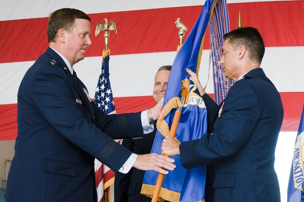 Col. Warren H. Hurst (right) accepts the guidon of the 123rd Airlift Wing from Kentucky's adjutant general, Maj. Gen. Edward W. Tonini, during a change-of-command ceremony held in the Fuel Cell Hangar at the Kentucky Air National Guard Base in Louisville, Ky., on Sept. 16, 2012. The formal ceremony signals the official transfer of power to from the previous wing commander, Col. Greg Nelson, to Hurst. (U.S. Air Force photo by Senior Airman Maxwell Rechel)