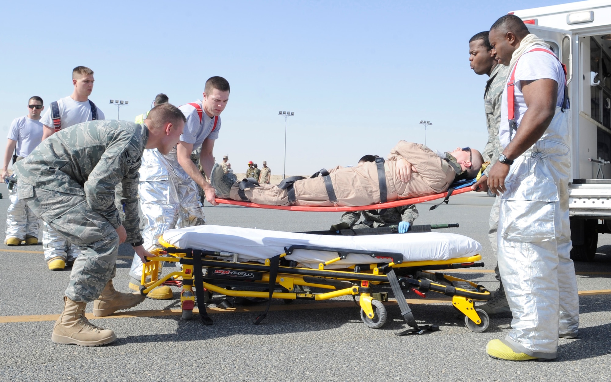 SOUTHWEST ASIA – Several members of the 386th Expeditionary Medical Group prepare to place a simulated victim in the ambulance during the major accident response exercise here Sept. 18. For this MARE, the wing responded to a simulated C-130 crash landing. (U.S. Air Force photo/Staff Sgt. Alexandra M. Boutte)