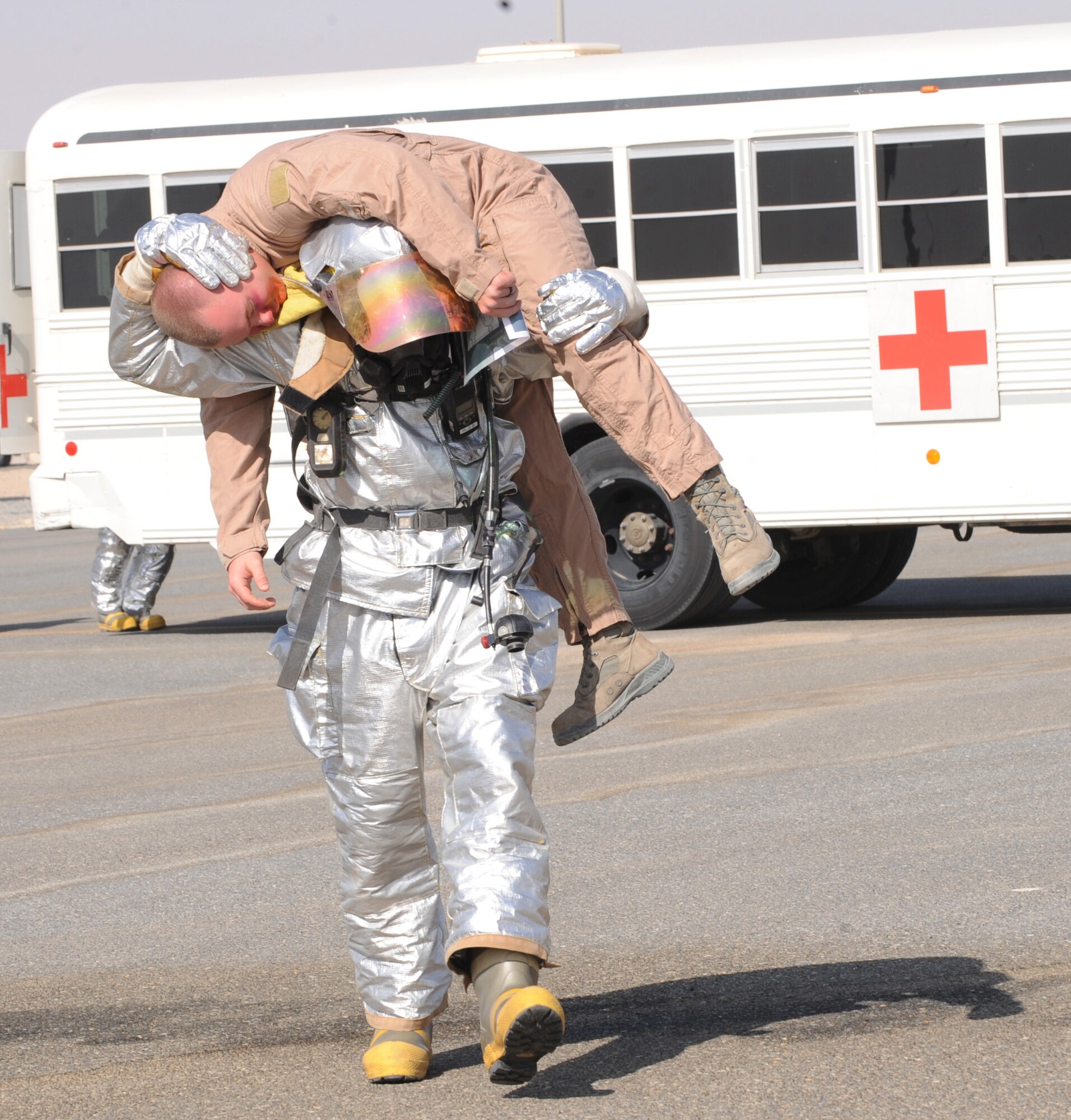 SOUTHWEST ASIA – A member of the 386th Expeditionary Civil Engineer Squadron fire department pulls a simulated victim out of the simulated C-130 crash site during the major accident response exercise here Sept. 18. The exercise allowed the wing and host nation partners an opportunity for all emergency responders to join forces and participate in a realistic scenario. (U.S. Air Force photo/Staff Sgt. Alexandra M. Boutte)