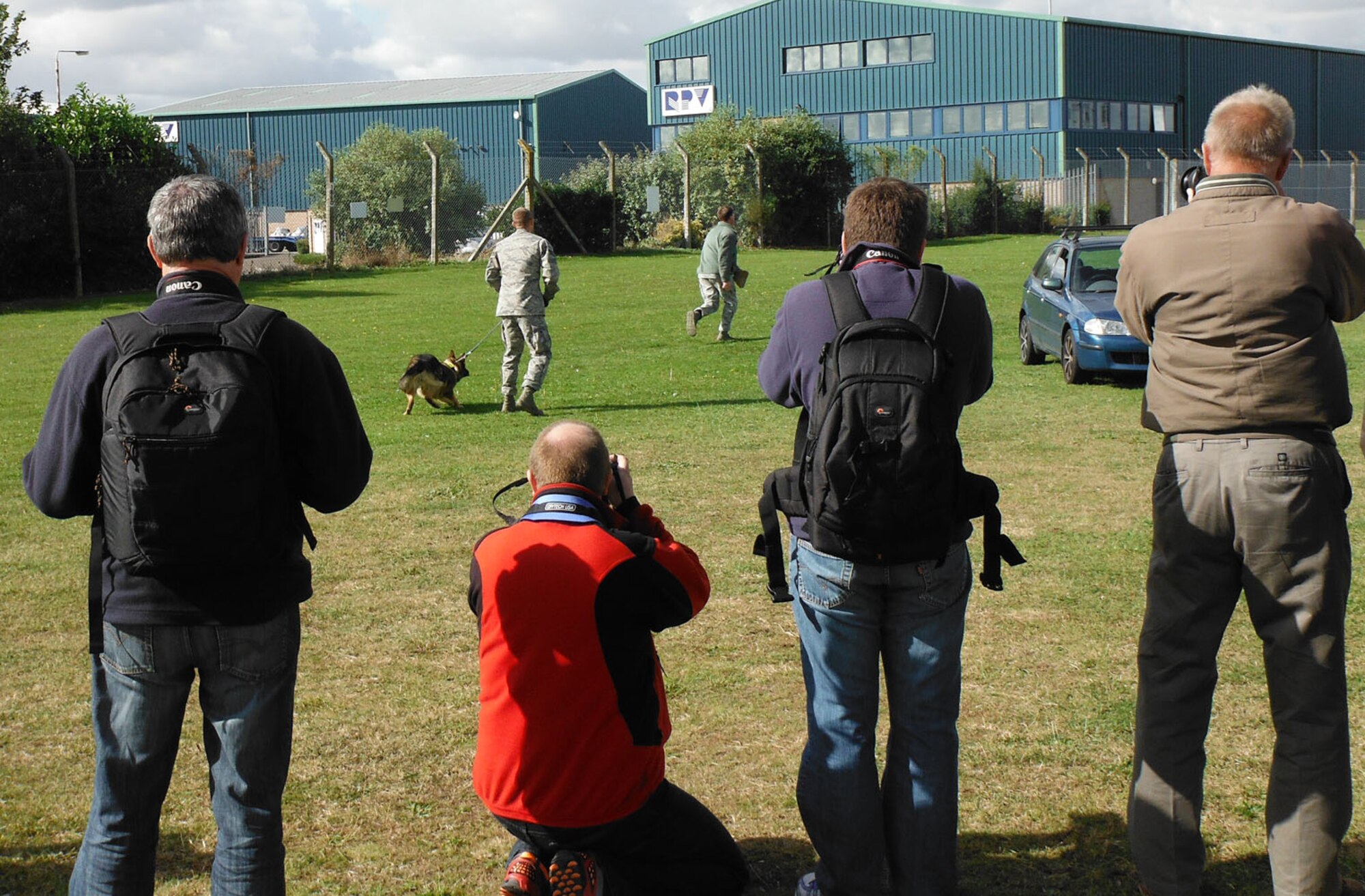 RAF MILDENHALL, England – Members of the Hertfordshire Aviation Society watch a military working dog demonstration during their base tour of RAF Mildenhall Sept. 18, 2012. In addition to the MWD demonstration, they dined at the Galaxy Club, received a mission brief from two aircrew from the 100th Operations Group, and visited a KC-135 Stratotanker static display. (U.S. Air Force photo/Karen Abeyasekere)