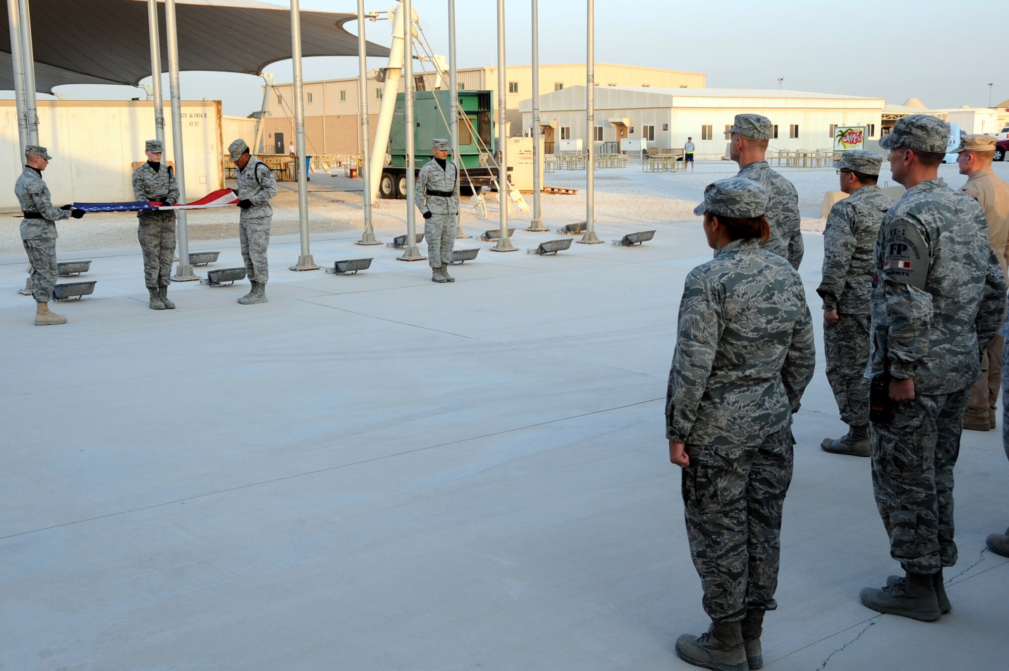 Members of the 379th Air Expeditionary Wing Honor Guard perform a flag folding ceremony to honor the 65th birthday of the Air Force in Southwest Asia, September 18, 2012. The 379th Honor Guard is comprised of volunteers who support special events from all services throughout the base. (U.S. Air Force photo/Staff Sgt. Sheila deVera)