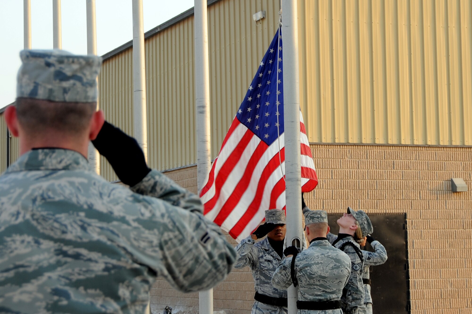 U.S. Air Force Airman 1st Class Barry Lindamood, 379th Air Expeditionary Wing Honor Guard renders a salute during a flag folding ceremony to honor the 65th birthday of the Air Force in Southwest Asia, September 18, 2012. The 379th Honor Guard is comprised of volunteers who support special events from all services throughout the base. (U.S. Air Force photo/Staff Sgt. Sheila deVera)