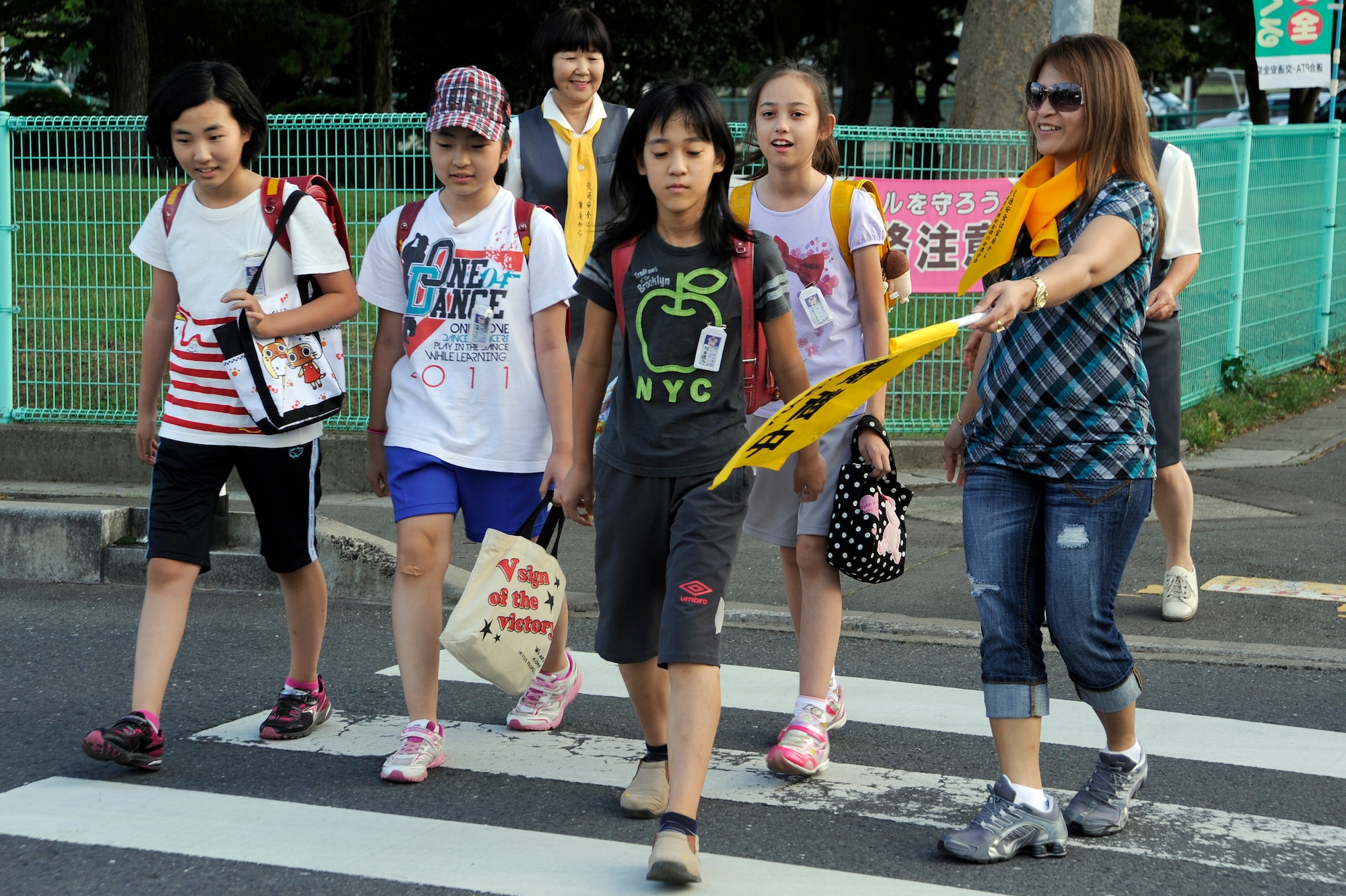 Margie Martin, Misawa City Mother's Association volunteer, helps local elementary school students safely cross the street during the National Autumn Traffic Safety Campaign in Misawa City, Japan, Sep. 20, 2012. The campaign is run by the Misawa City Mother's Association, which strives to correct traffic manners and teach children how to walk and ride bicycles safely. (U.S. Air Force photo by Tech. Sgt. Marie Brown)
