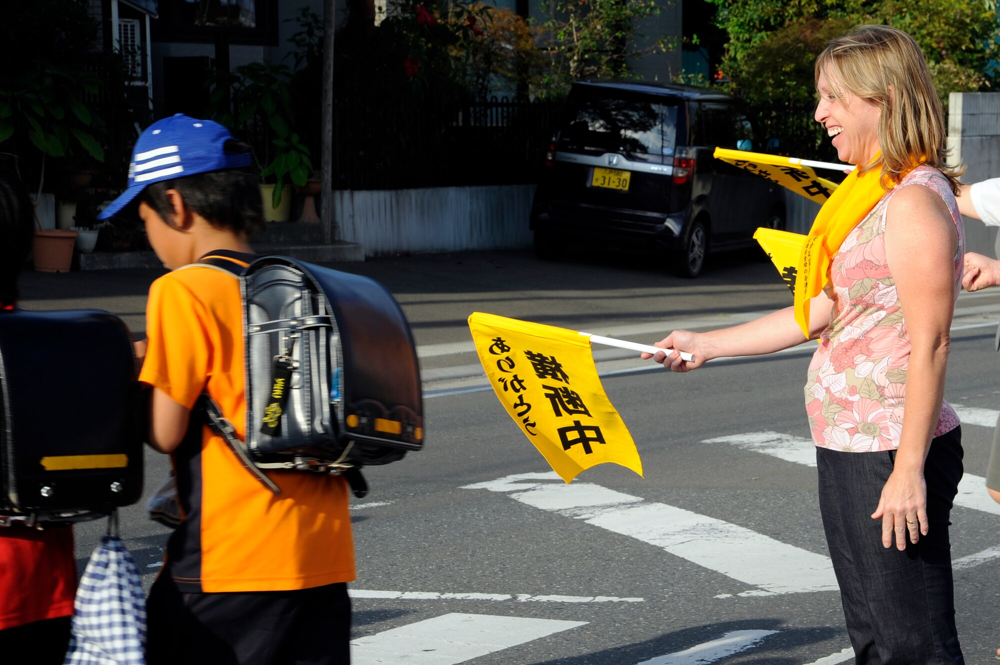 Misty Griffin, Misawa City Mother's Association volunteer, stops traffic for children during the National Autumn Traffic Safety Campaign near an elementary school in Misawa City, Japan, Sept. 20, 2012. Misawa City Mother's Association for Traffic Safety promotes traffic safety awareness, which focuses on protecting the elderly and children. (U.S. Air Force photo by Tech. Sgt. Marie Brown)
