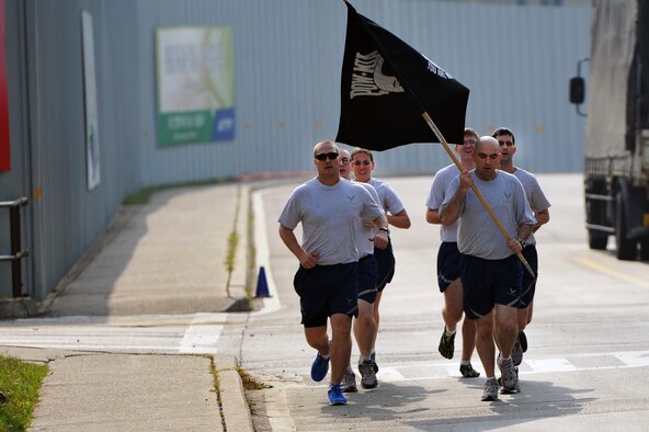 Airmen participate in a Prisoner of War/Missing in Action 24-hour run at Osan Air Base, Republic of Korea, Sept. 21, 2012. The National POW/MIA Recognition Day is annually observed in the United States on the third Friday of September. The base held observances throughout the week to remember the more than 83,000 Americans who are missing from World War II, the Korean War, the Cold War, the Vietnam War and the 1991 Gulf War. (U.S. Air Force photo/Staff Sgt. Craig Cisek)