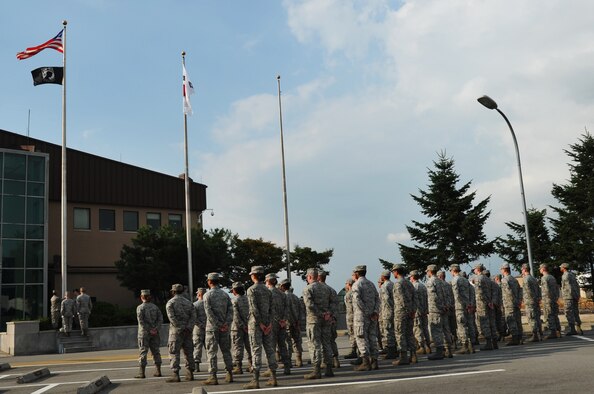 Airmen participate in a Prisoner of War/Missing in Action retreat ceremony at Osan Air Base, Republic of Korea, Sept. 20, 2012. Osan held several events throughout the week to include a 24-hour run and candlelight vigil, to remember the more than 83,000 Americans who are missing from World War II, the Korean War, the Cold War, the Vietnam War and the 1991 Gulf War. (U.S. Air Force photo/Staff Sgt. Craig Cisek)