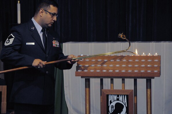 Master Sgt. Richard Martinez, 51st Communications Squadron Quality Assurance NCO, begins the lighting ceremony at a Prisoner Of War/Missing In Action candlelight vigil at the Osan Air Base chapel, Republic of Korea, Sept. 19, 2012. The 52 candles represent a service member from each state, a territory and the District of Columbia who are listed as POW/MIA. In remembrance of POW/MIA week, Osan held a retreat, a 24-hour run with the POW/MIA flag, and a remembrance and memorial dedication ceremony. (U.S. Air Force photo/Staff Sgt. Craig Cisek)