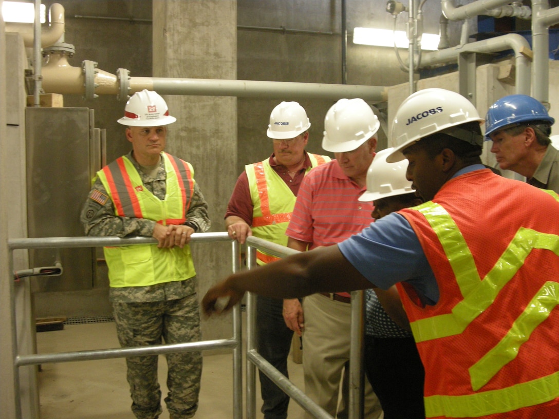 Col. Charles Klinge, commander, Fort Worth District, is briefed inside the control room of the new Pavaho Pump Station along the West Levee in West Dallas Aug. 16. Pavaho is connected to two separate power substations so it can continue to provide power to the pumps even if one of the substations is knocked out during a storm. The city of Dallas’ project to greatly expand pumping capacity at Pavaho reduces neighborhood flooding by draining water more quickly into the Trinity River. The station becomes fully operational at the end of October.