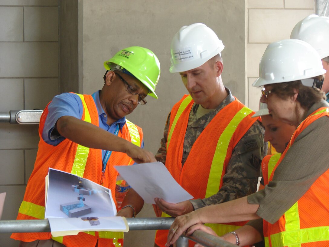 Sirak Bahta, a city engineer, explains to Brig. Gen. Thomas W. Kula how the three new pumps work. Together they can pump 375,000 gallons per minute out of West Dallas neighborhoods – the equivalent of being able to fill an Olympic-sized swimming pool in less than two minutes.  Total Flood Control System pumping capacity for all of the city’s pumping stations is the equivalent of filling up White Rock Lake from scratch in a single day.