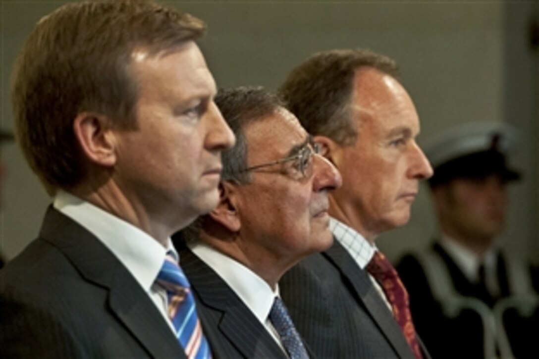 U.S. Defense Secretary Leon E. Panetta, center, stands with New Zealand Defense Minister Jonathan Coleman, left, and Roy Clare, museum director, at a wreath at the World War II Hall of Memories at the Auckland War Memorial Museum in Auckland, New Zealand, Sept. 21, 2012. Panetta visited Tokyo and Beijing before traveling to Auckland to conclude a weeklong trip to the Asia-Pacific region.