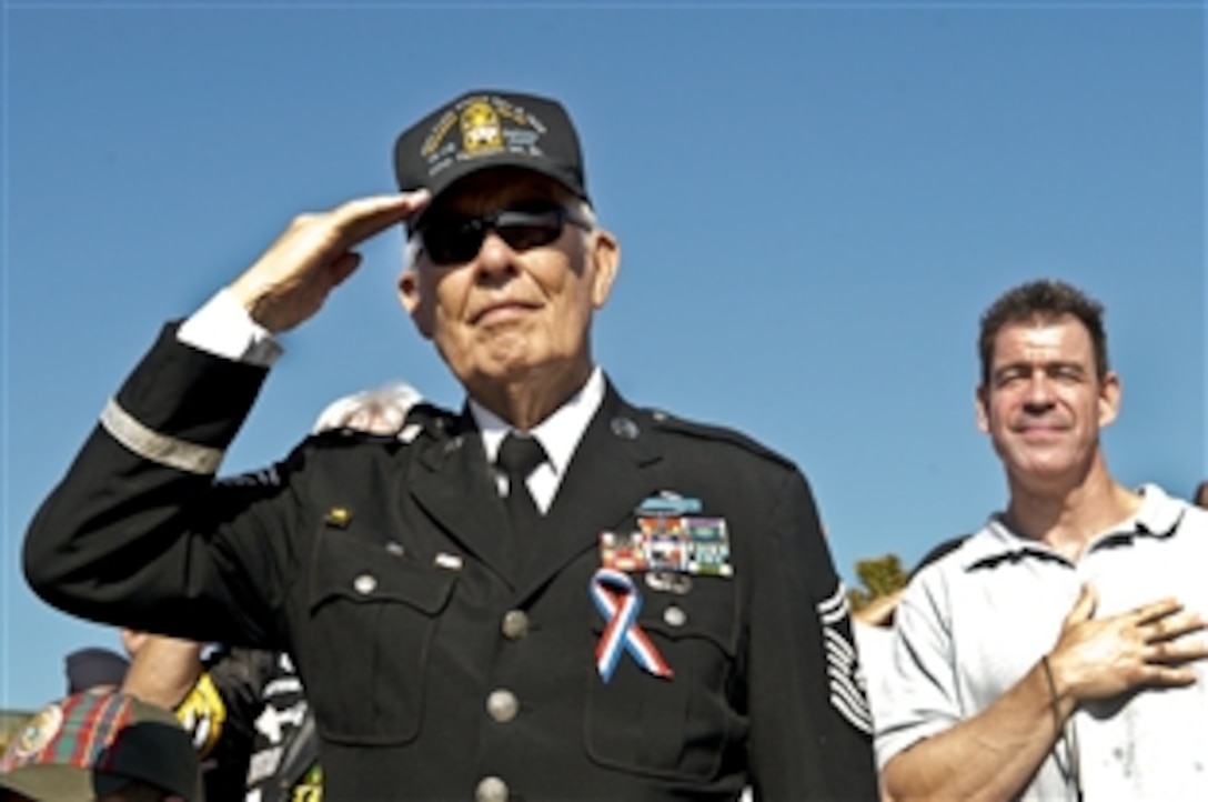 A former Air Force senior master sergeant and prisoner of war renders a honors during the playing of the national anthem at the National POW/MIA Recognition Day ceremony at the Pentagon, Sept. 21, 2012. The ceremony hosted former prisoners of war, family members, military Service Members and distinguished guests.