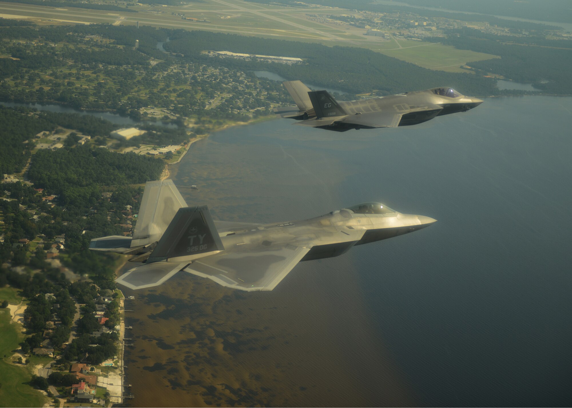 An F-22A Raptor, foreground, from the 43rd Fighter Squadron at Tyndall Air Force Base, Fla., and an F-35A Lightning II joint strike fighter from the 33rd Fighter Wing at Eglin Air Force Base, Fla., soar over the Emerald Coast Sept. 19, 2012. This was the first time the two fifth-generation fighters have flown together for the Air Force. (U.S. Air Force photo/Master Sgt. Jeremy T. Lock)