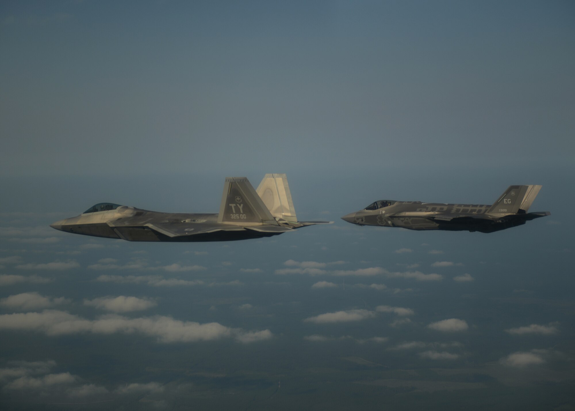 An F-22A Raptor, left, from the 43rd Fighter Squadron at Tyndall Air Force Base, Fla., and an F-35A Lightning II joint strike fighter from the 33rd Fighter Wing at Eglin Air Force Base, Fla., soar over the Emerald Coast Sept. 19, 2012. This was the first time the two fifth-generation fighters have flown together for the Air Force. (U.S. Air Force photo/Master Sgt. Jeremy T. Lock)