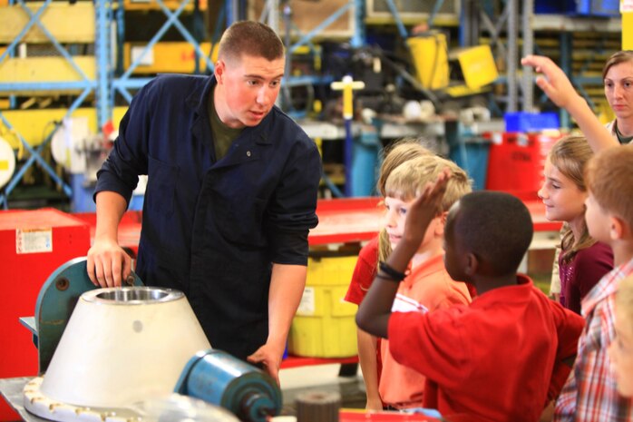 Cpl. Joshua L. Isaacson, an Amphibious Assault Vehicle mechanic with 2nd Maintenance Battalion, 2nd Marine Logistics Group, answers questions about parts for the AAV during the battalion’s open house aboard Camp Lejeune, N.C., Sept. 19, 2012. Isaacson and other Marines with the battalion ran displays for family and friends to see the responsibilities their units perform in support of operations.