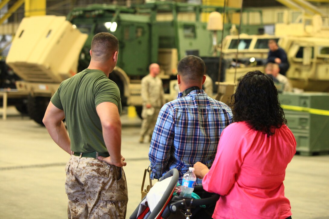 A family joins a Marine with 2nd Maintenance Battalion, 2nd Marine Logistics Group as he observes the battalion’s personnel conducting maintenance operations during the unit’s open house aboard Camp Lejeune, N.C., Sept. 19, 2012. The battalion opened the doors to its facilities to provide visitors with a glimpse of what it does to support units aboard the base.