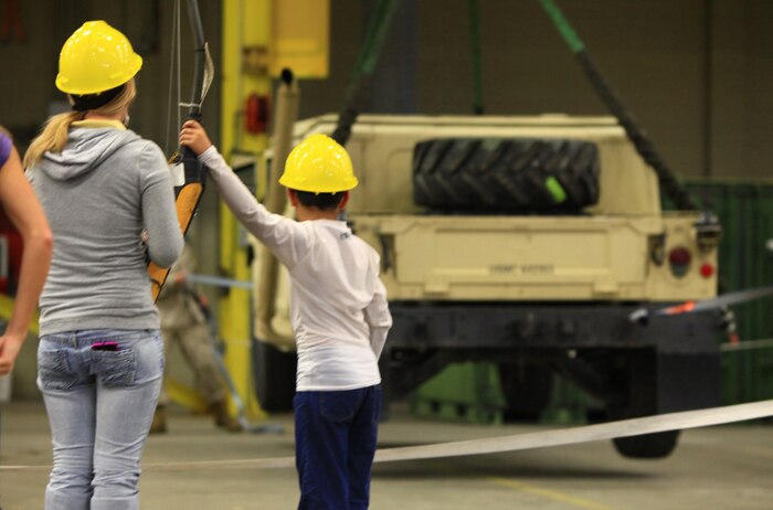 Two children operate a hoist used to lift heavy equipment as part of the 2nd Maintenance Battalion, 2nd Marine Logistics Group open house aboard Camp Lejeune, N.C., Sept. 19, 2012. The battalion’s six companies set up vehicle displays to inform their families and friends about the battalion’s mission within the Marine Corps. 