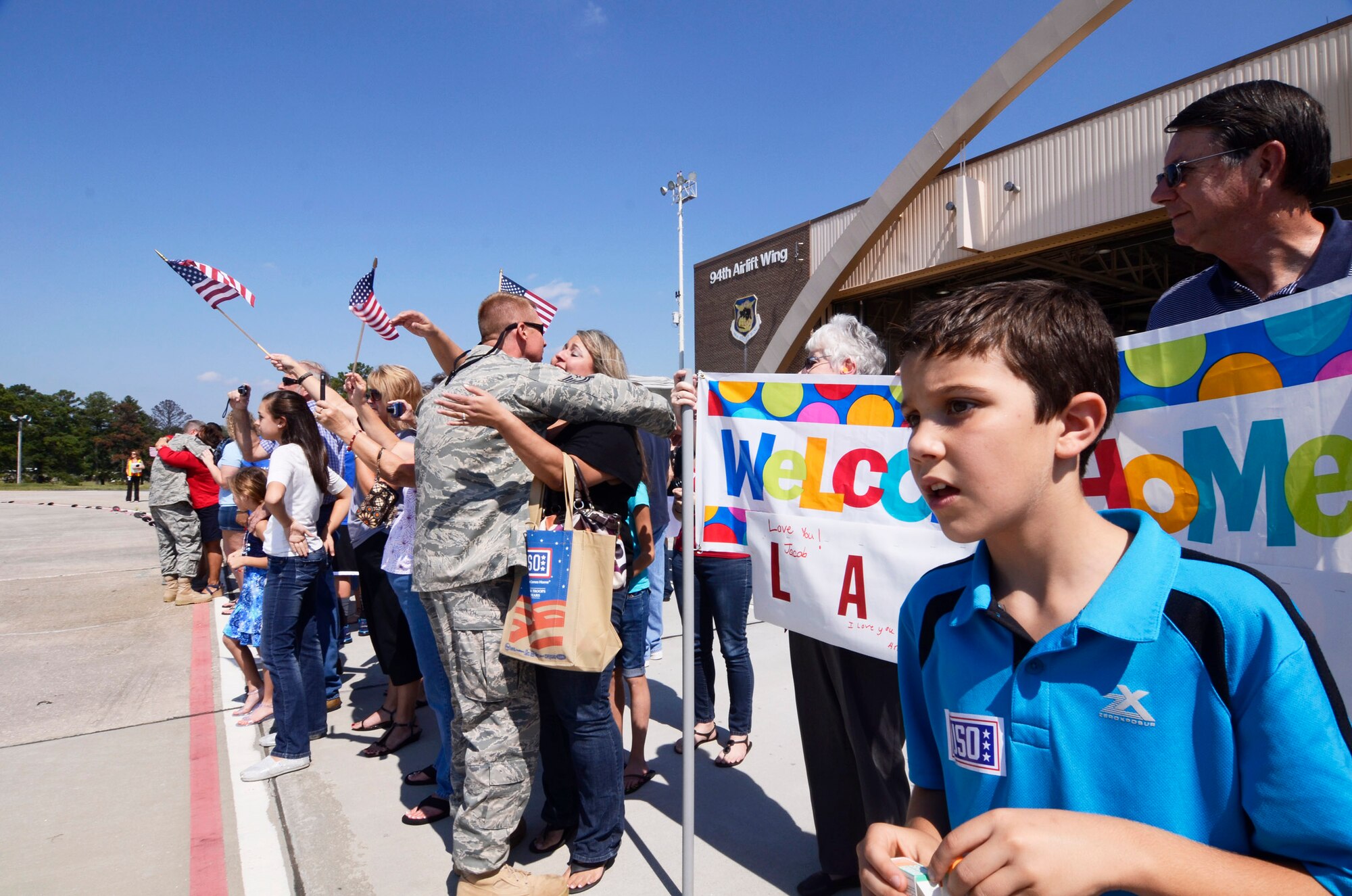 Members of the 94th Airlift Wing are welcomed home during a homecoming ceremony at Dobbins Air Reserve Base Sept. 22. Over 100 Reservists are scheduled to return to Dobbins ARB from the Middle East Sept. 21-24. (U.S. Air Force photo/Don Peek)